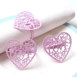 Pink heart napkin ring with LOVE cutout design on white napkin for Valentine decoration