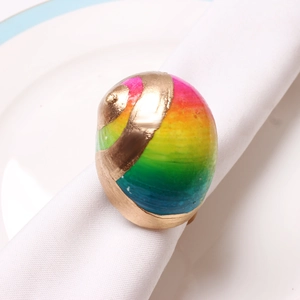 Detail of creative rainbow snail shell napkin ring with gold metallic spiral accents