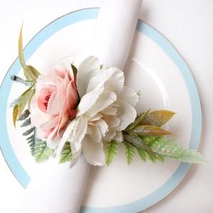 Pink rose napkin ring with lifelike green leaves for elegant wedding table setting