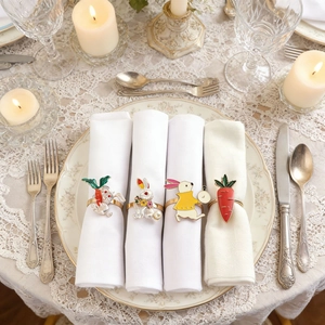 Detail of bunny and carrot napkin rings set on a vintage lace tablecloth setting