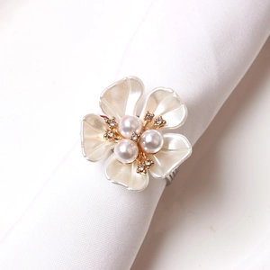 Elegant pearl flower napkin ring with rhinestones on a gold base for wedding decor