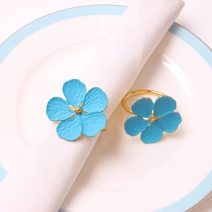 Light blue plum blossom napkin rings with gold metal bands for elegant table settings