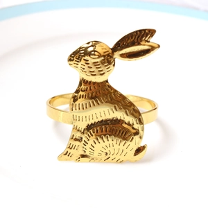 Détail d'un rond de serviette lapin doré avec une texture métallique gravée avec précision