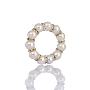 Handmade pearl and rhinestone napkin ring set against a clean white reflective background