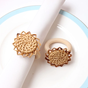 Detail of sunflower rattan napkin ring with woven petals on white ceramic plate