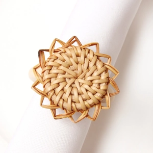 Detailed view of handmade rattan napkin ring in sunburst shape for table decor