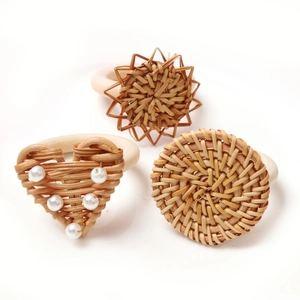 Handmade woven rattan napkin rings in heart, star, and round shapes with pearl accents