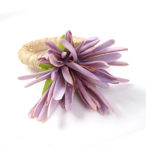 Macro detail of artificial purple flower with handcrafted rustic woven napkin ring