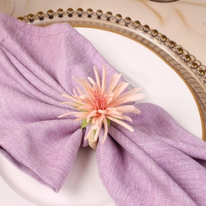 Champagne artificial flower napkin ring on light purple linen for elegant dining decor