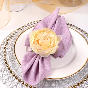 Elegant cream peony flower napkin ring with purple linen cloth on white gold dinner plate