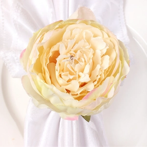 Modern napkin ring featuring a large cream peony flower on elegant white table setting
