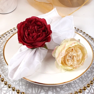 Detailed close-up of realistic deep red and white peony napkin rings for dining decor
