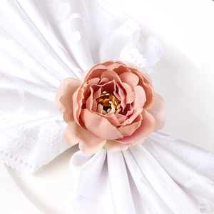Elegant champagne pink peony napkin ring with silk petals on white lace linen fabric