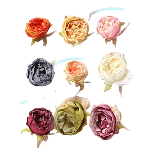 Nine colorful artificial peony napkin rings with jute wrapped stems on white background