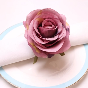 Detailed view of vintage peony napkin ring with silk petals on a white dining plate