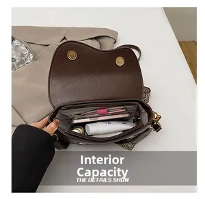 Detail of vintage saddle bag interior with herringbone lining and ethnic shoulder strap