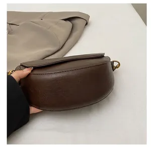 Detail showing durable wear-resistant bottom of vintage brown leather saddle bag