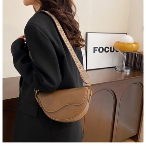 Brown faux leather saddle bag with ethnic jacquard wide strap and gold hardware accents