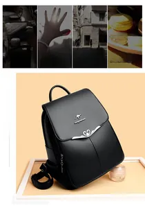Detail of black leather backpack with lychee texture and kangaroo logo on metal hardware