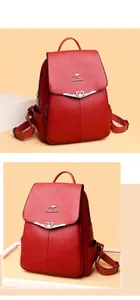 Detail of red litchi leather backpack with heart buckle and silver kangaroo logo accent