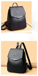 Detail of black pebbled leather backpack featuring metallic kangaroo logo and wing-heart trim