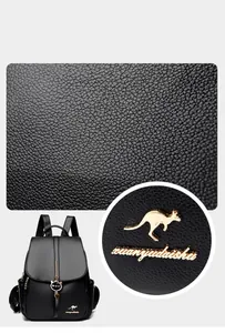 Detail of lychee textured leather and golden kangaroo logo on black backpack