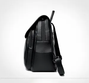 Detail view of black lychee grain PU leather backpack showing side zipper pockets