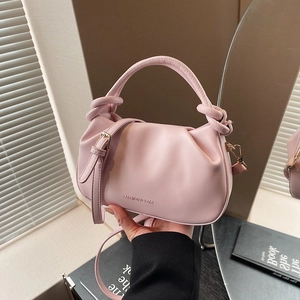 Pink pleated bucket bag with knot handle and adjustable strap for casual fashion