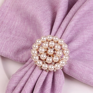 Golden pearl napkin ring with triple layer round design and sparkling rhinestone accents