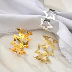 Star-shaped metal napkin rings in gold and silver finish for elegant table decor