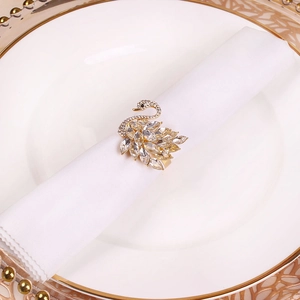 Close-up of golden swan napkin ring featuring marquise-cut crystals and elegant details