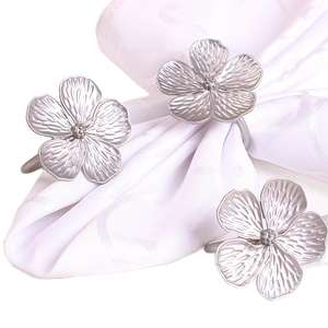 Matte silver plum blossom napkin rings with five petals and realistic plant textures
