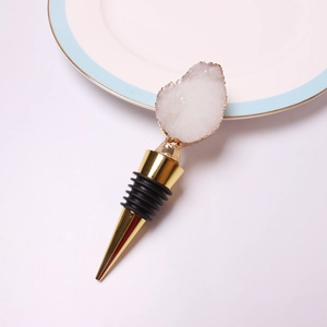 Macro shot of gold wine stopper with white quartz crystal and black silicone rings