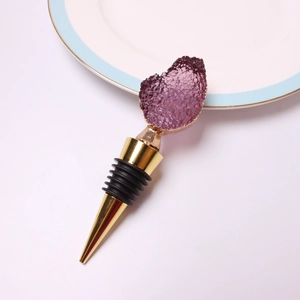 Detail of purple crystal wine stopper with gold plating and black rubber seal ring