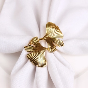 Close-up of golden ginkgo leaf napkin ring showing detailed metallic veins and texture