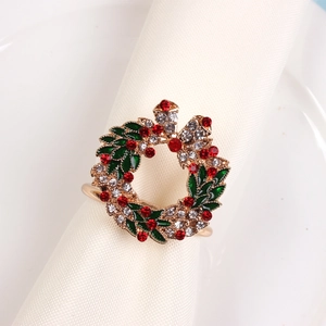 Detailed view of Christmas wreath napkin ring with red rhinestones and green enamel
