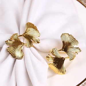 Macro detail of golden ginkgo leaf napkin ring showing intricate metal leaf textures