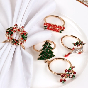 Detail of Christmas napkin rings set featuring gold deer, tree, and wreath with rhinestones