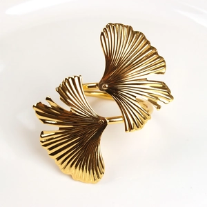 Elegant gold ginkgo leaf napkin ring with detailed metal texture and polished finish
