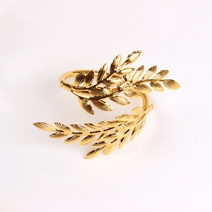 Macro shot of gold wheat ear napkin ring with detailed texture and polished finish