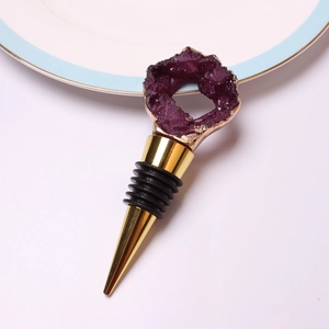 Detail of purple crystal wine stopper with gold edging and silicone seal rings