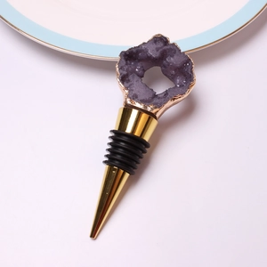 Close-up of a purple geode crystal wine stopper with a gold rim and black rubber seal