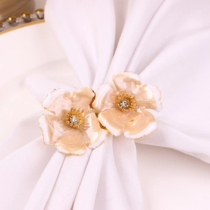 Detail of gradient enamel double flower napkin rings with crystal center on silk