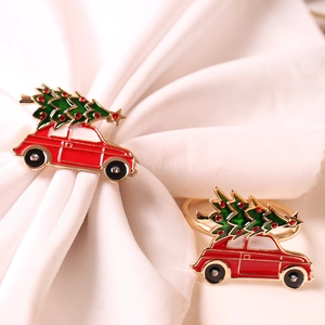 Close-up of red car and Christmas tree napkin rings with crystal diamond accents