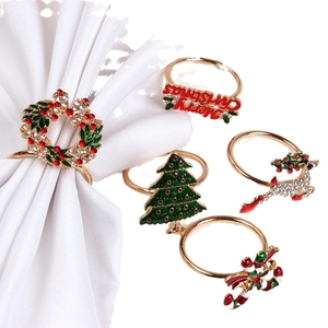 5-piece gold Christmas napkin ring set with reindeer, tree, wreath, and bell designs