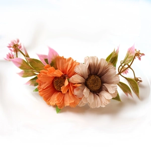 Daisy flower napkin ring featuring handmade orange and beige petals on white background