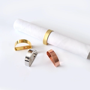 Detail view of D-shaped metal napkin rings in gold, silver, and rose gold finishes