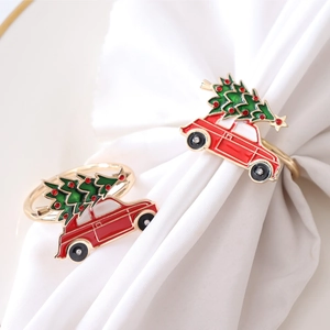Golden Christmas napkin rings featuring red car and green tree with rhinestones