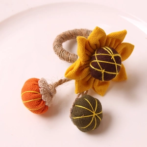 Autumn style napkin ring with sunflower, pumpkin, and twine for seasonal table decor