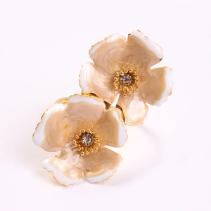 Elegant champagne and white double flower napkin rings with rhinestone centers